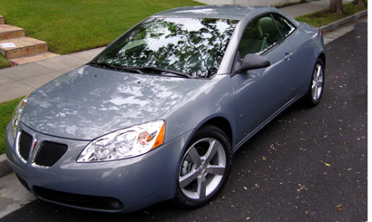 A three-quarter front view of a Pontiac G6 GT Convertible with its hardtop up